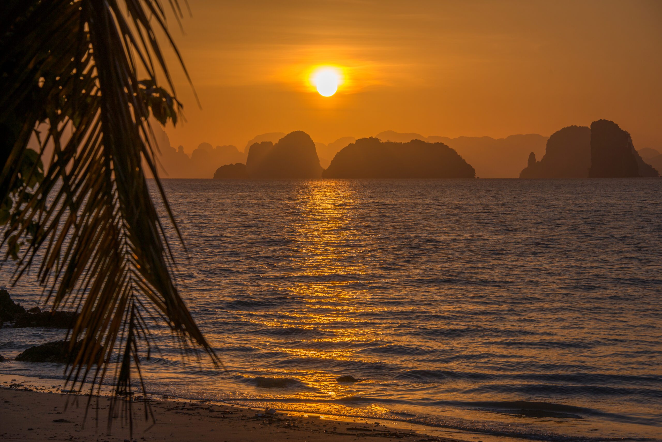 Sunset And A Silhouette Of Islands