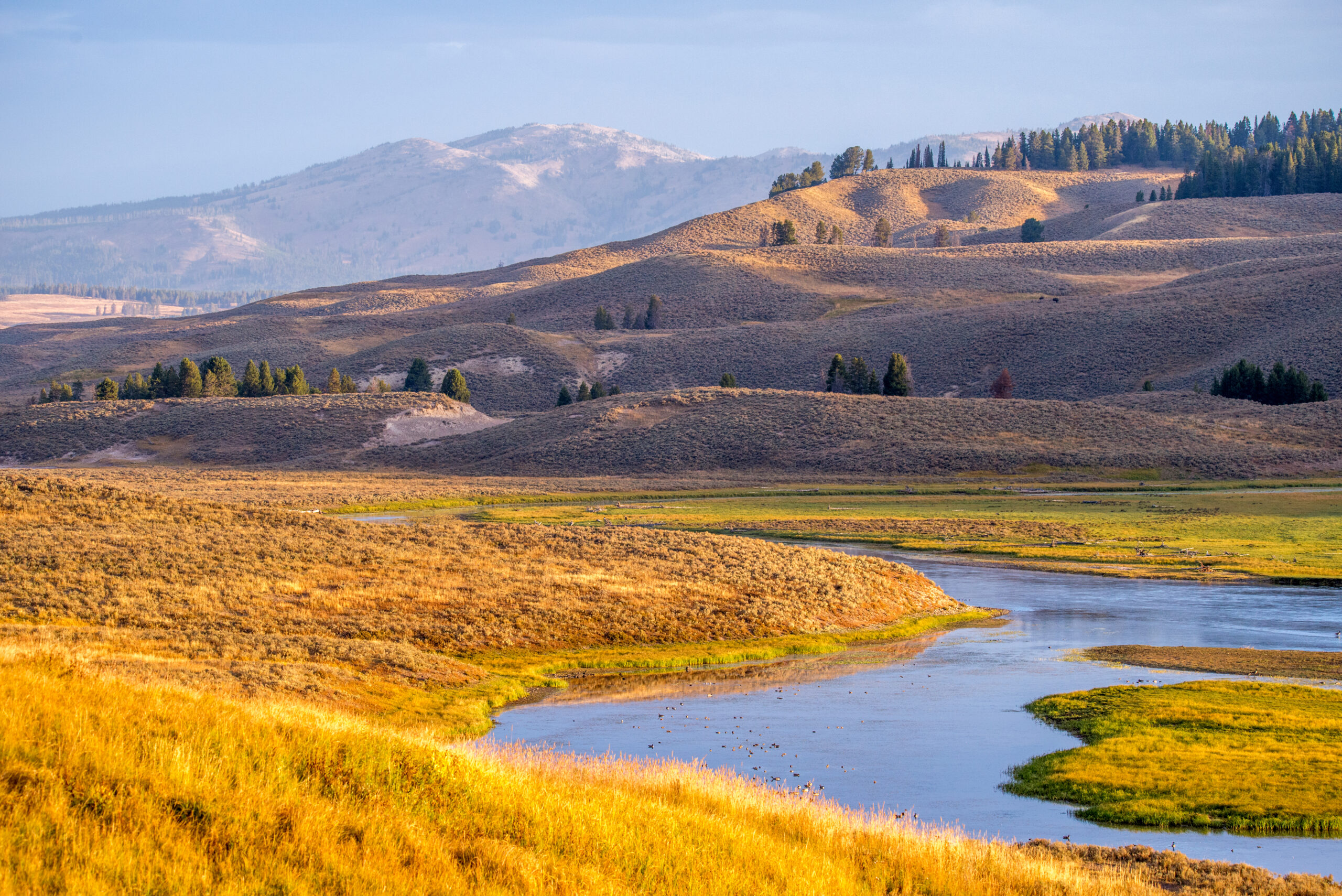 A View Of A River Below The Hills